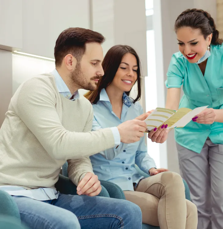 A couple reviewing treatment options with a Birch Tree Dentistry team member